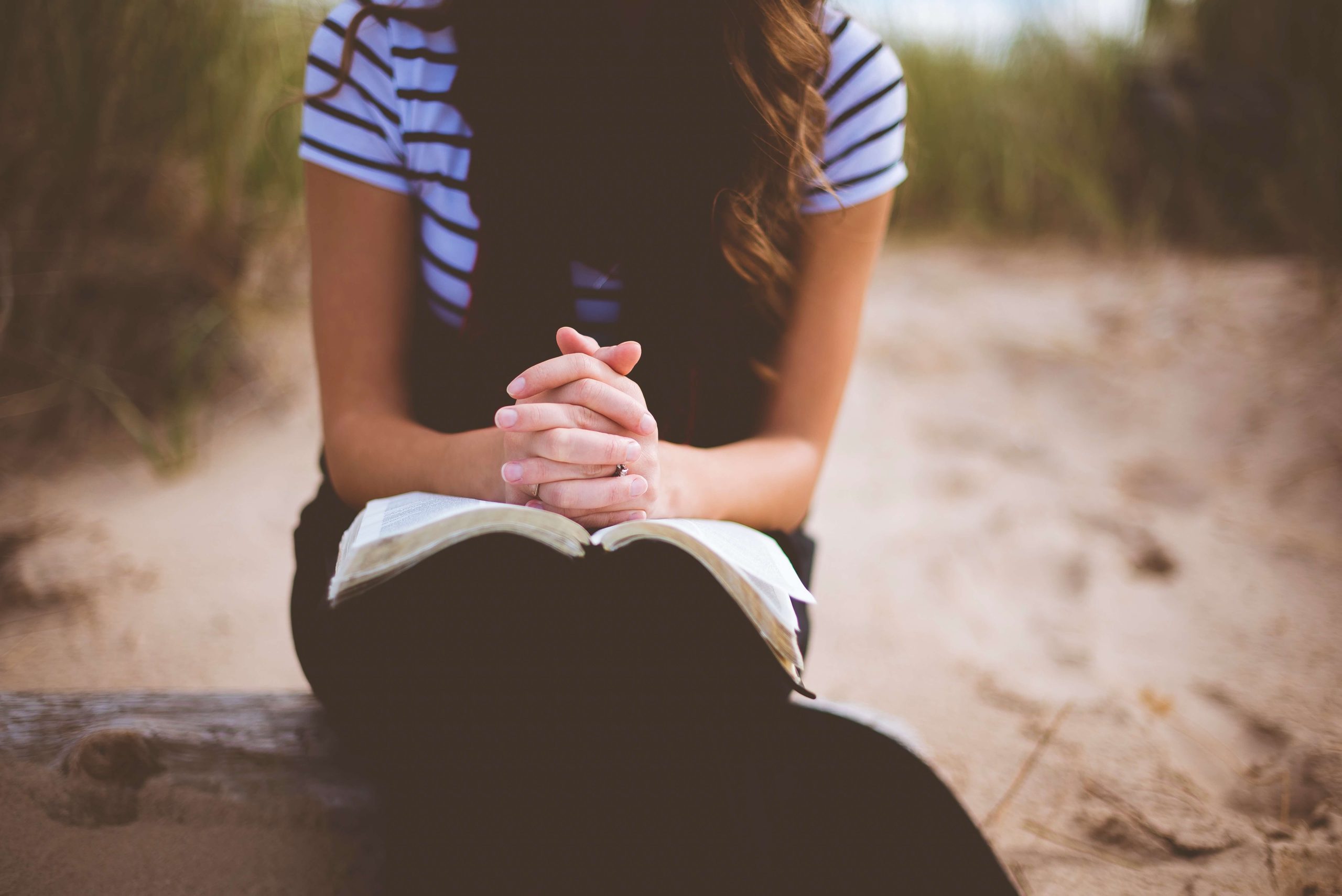 A woman praying — faith is foundational to a Christian AI companion